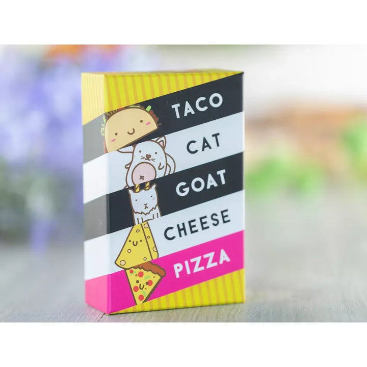 Box of 'Taco Cat Goat Cheese Pizza' with colorful design on a blurred background