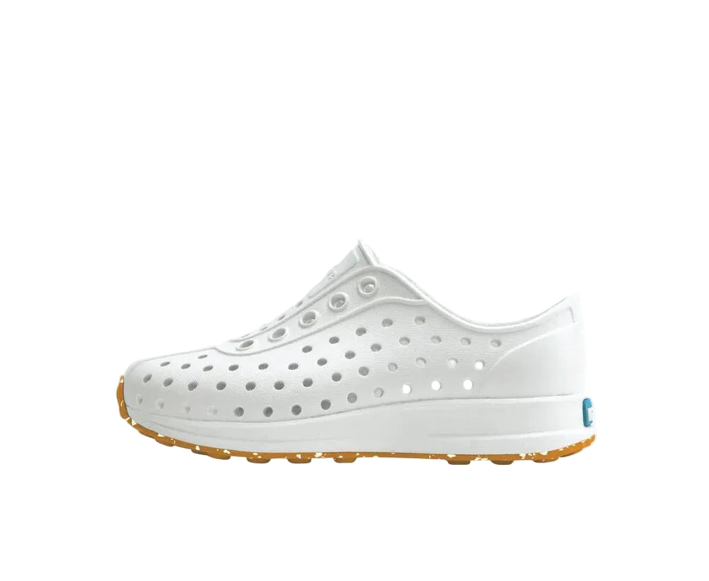 White shoe with brown sole on a white background