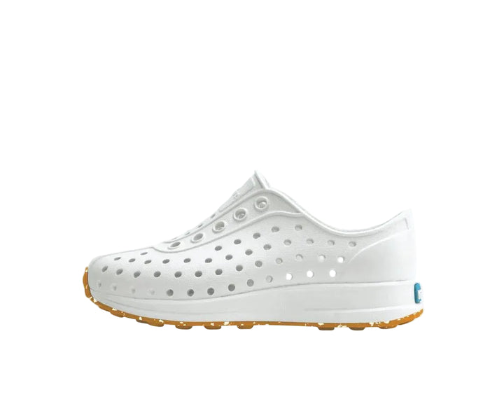 White shoe with brown sole on a white background