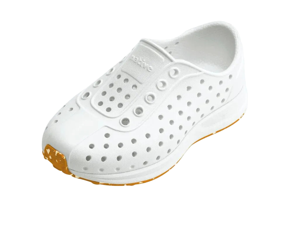White clog shoe with orange sole on a light gray background