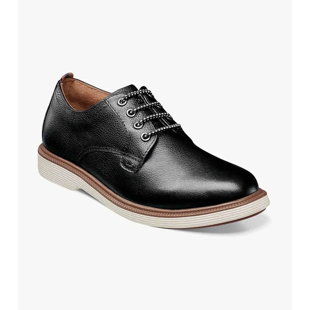 Black leather shoe with brown accents on a white background