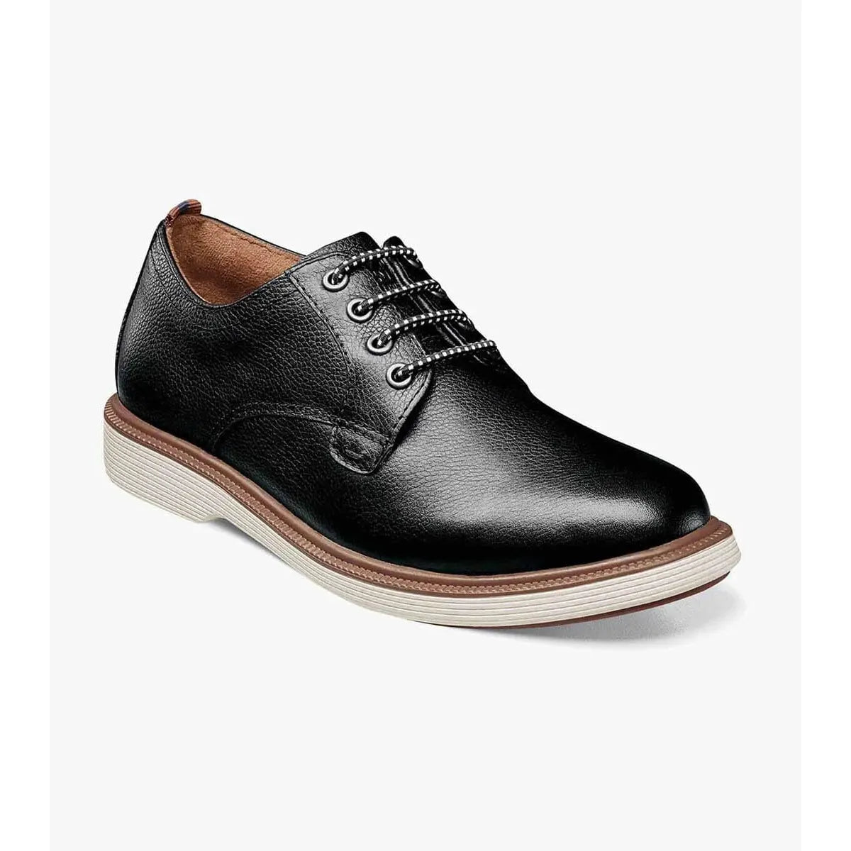 Black leather shoe with brown accents on a white background