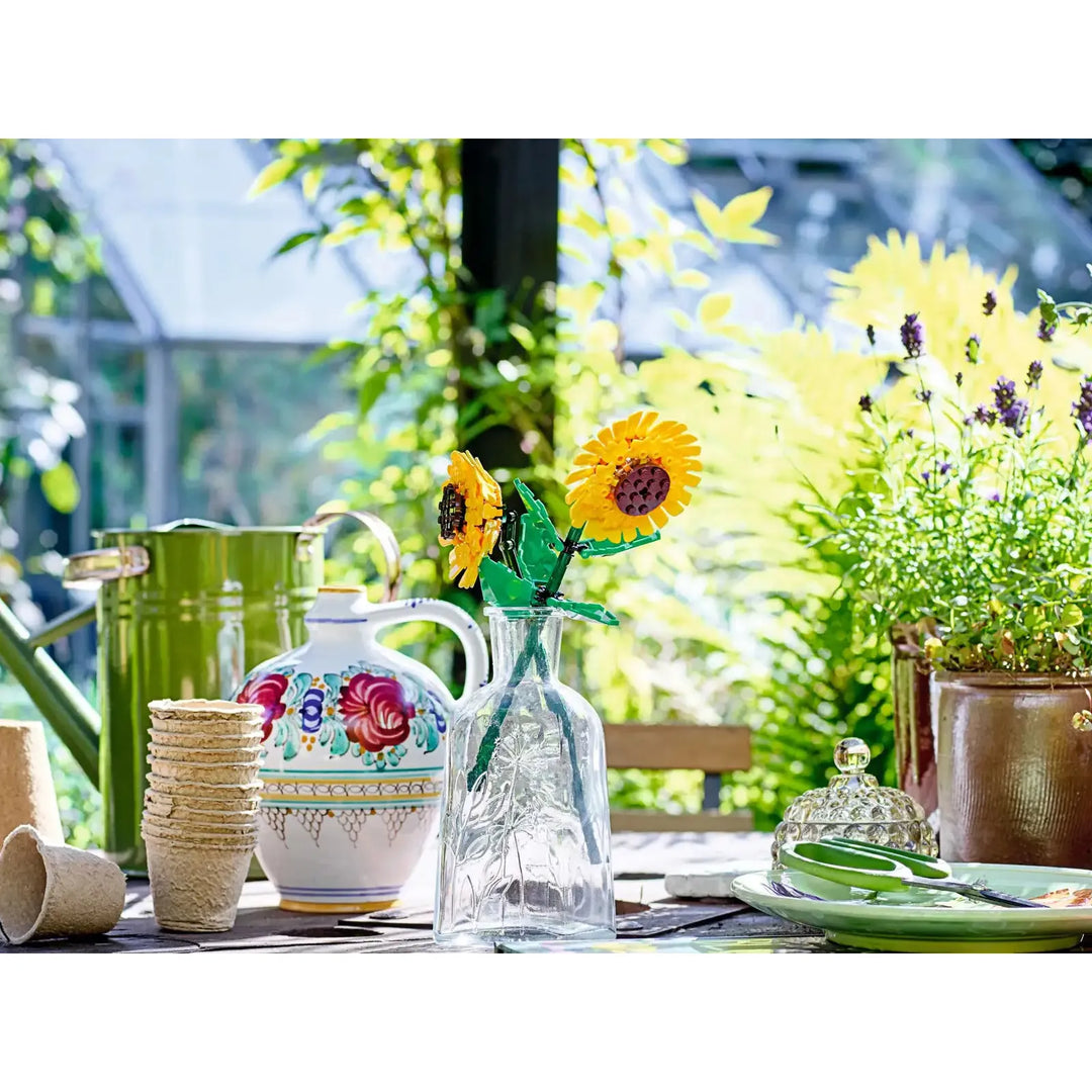 Outdoor table setting with floral decorations and greenery