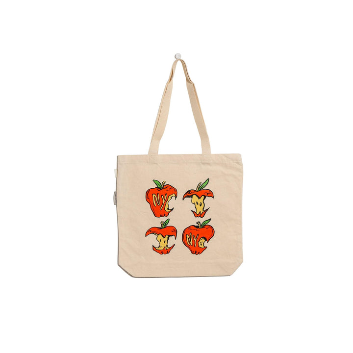 Beige tote bag with cartoon apple design on a light gray background
