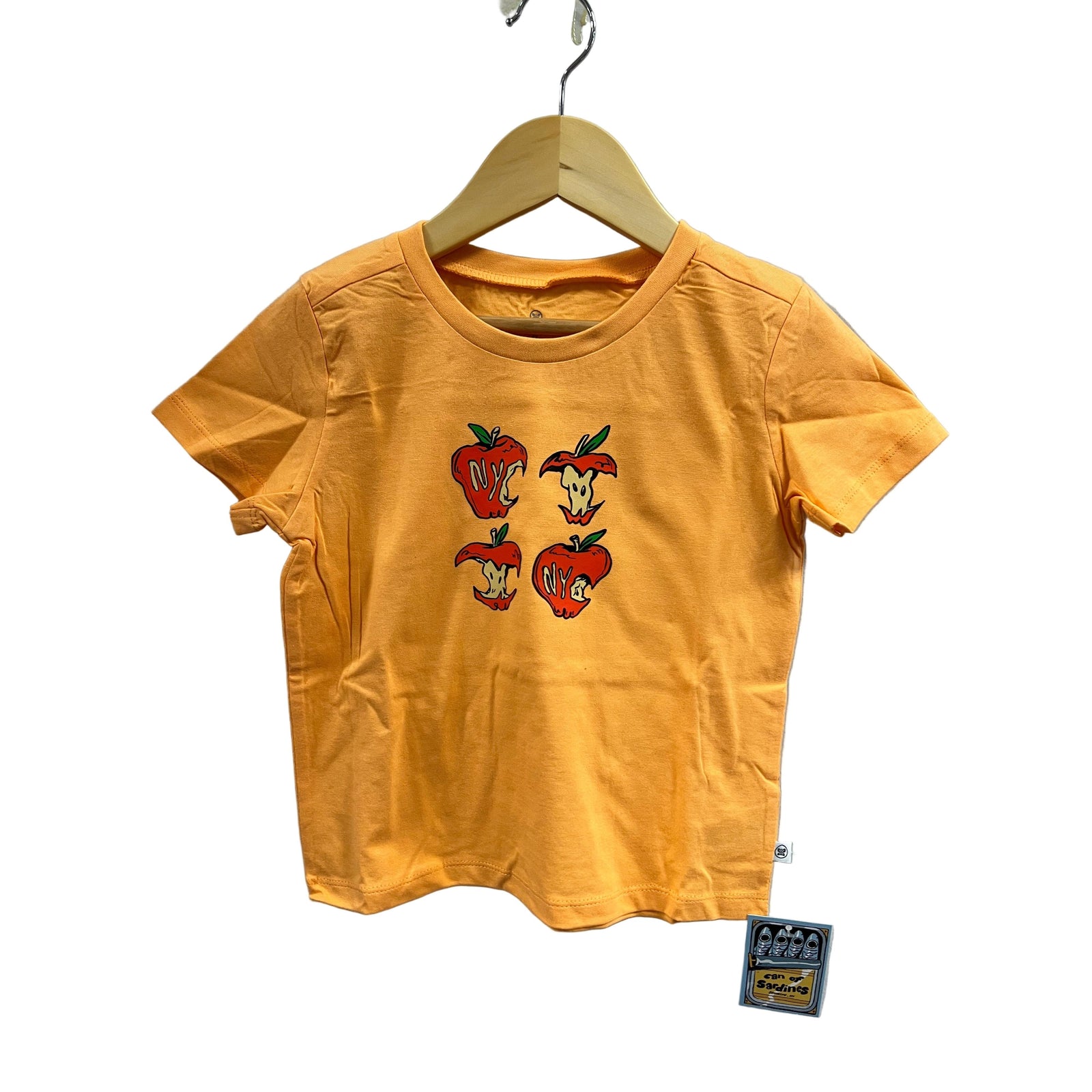 Yellow t-shirt with cartoon character design on a hanger against a gray background