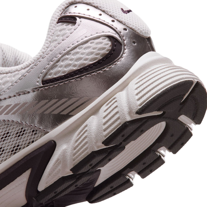 Close-up of a running shoe with tread pattern on a white background