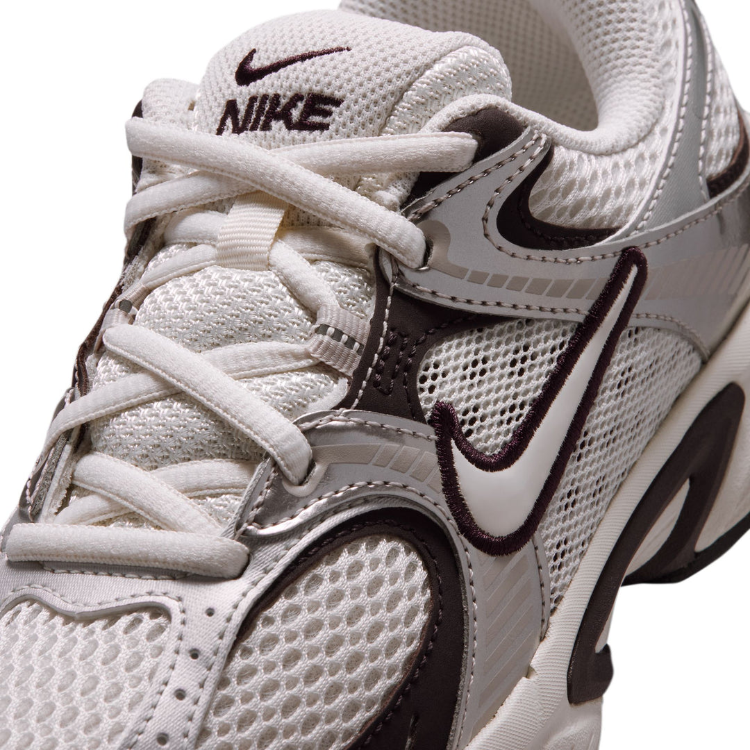 White and brown Nike sneaker on a white background