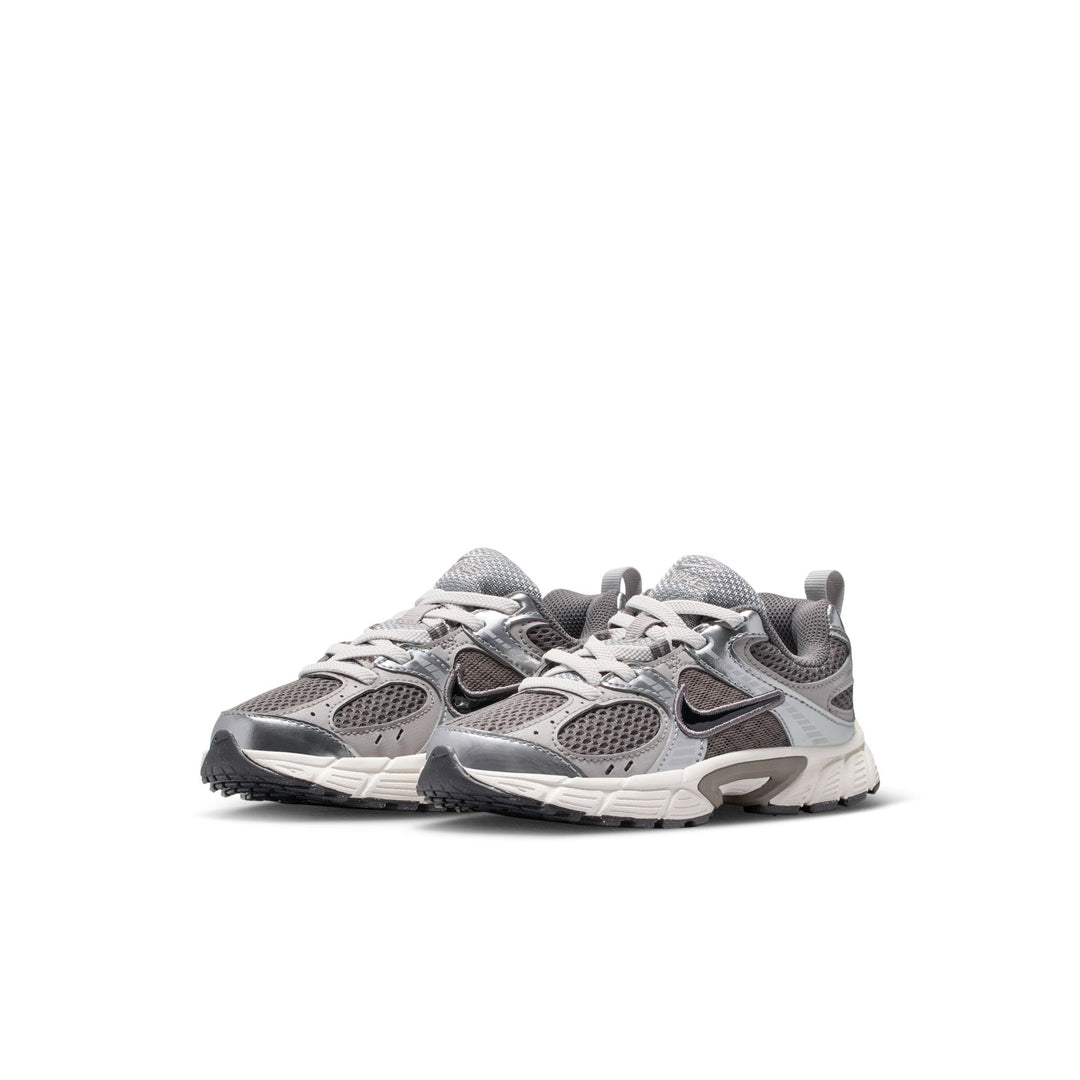 A pair of Nike Air Max 90 sneakers in gray and white, featuring the classic Swoosh design, shown against a plain white background.