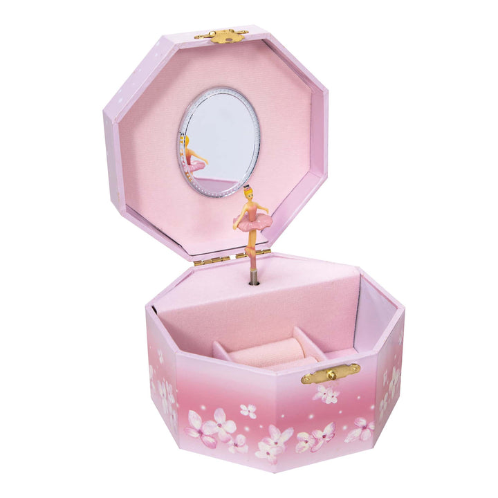 A pink musical jewelry box with a ballerina in a tutu twirling inside, opened to show the interior compartments.