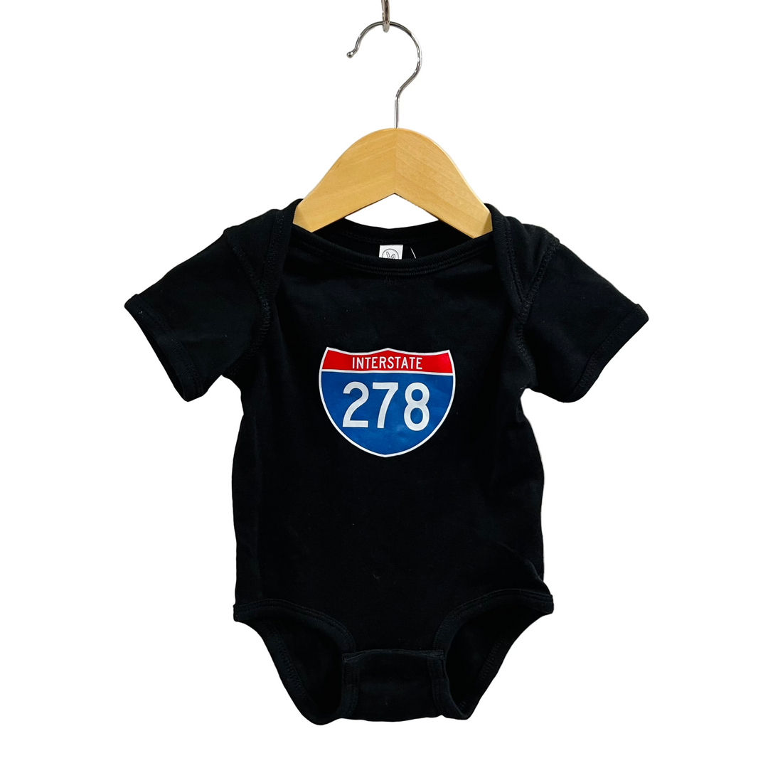 Black baby onesie with Interstate 278 design on a hanger against a white background