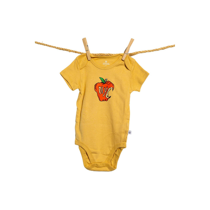 Yellow baby onesie with a colorful design on a clothesline against a white wall.