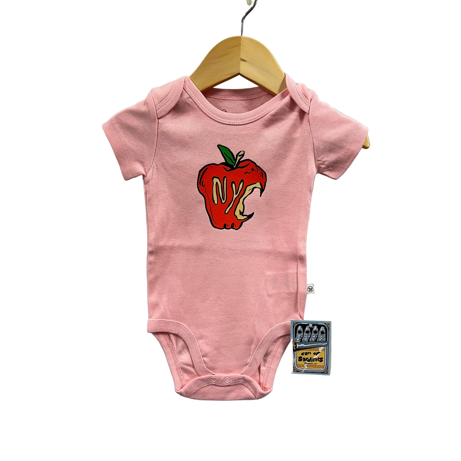 Pink baby onesie with a graphic design on a gray background