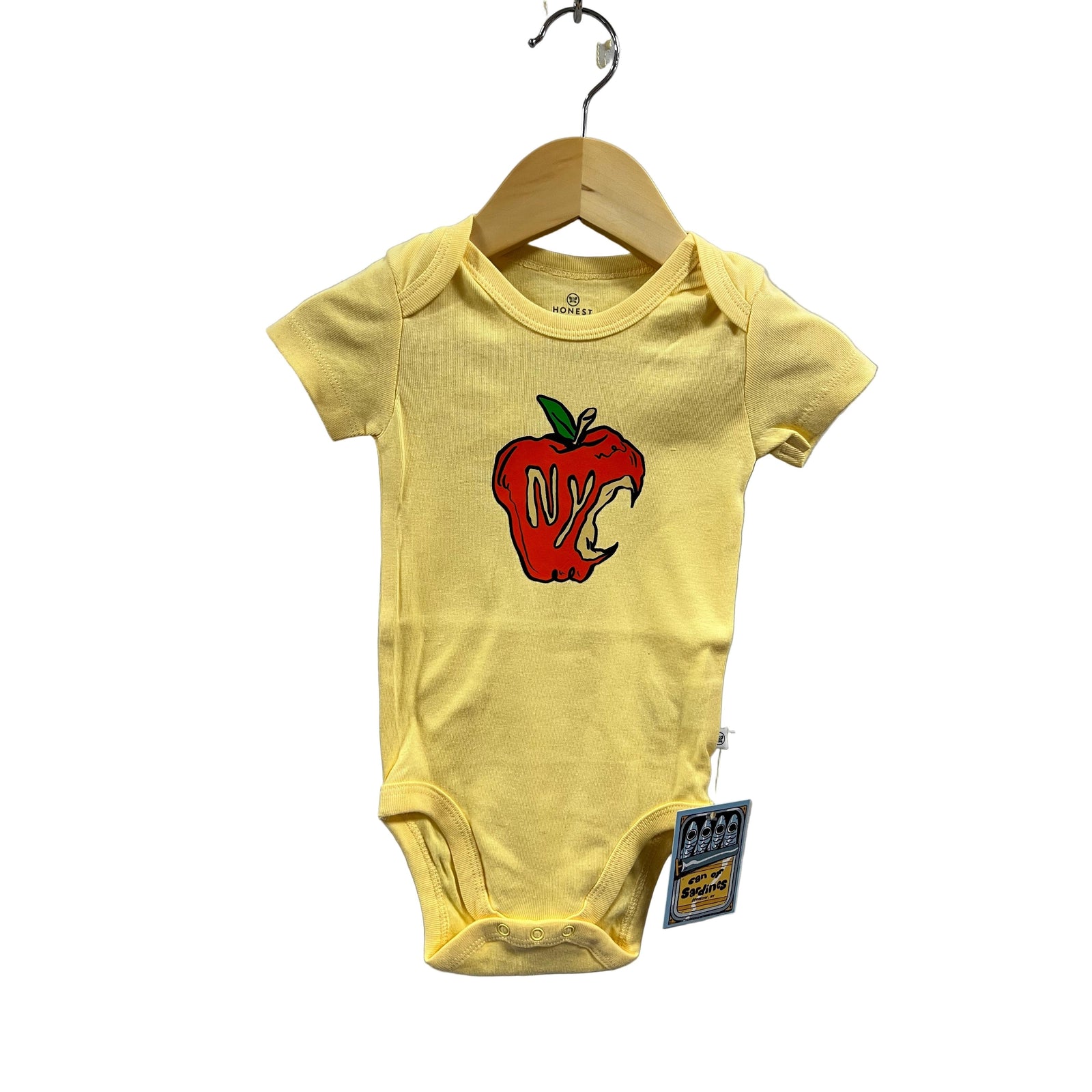 Yellow baby onesie with a red and black design on a hanger against a gray background