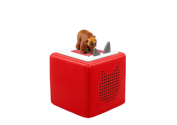 Red toy box with a bear figurine on top on a white background