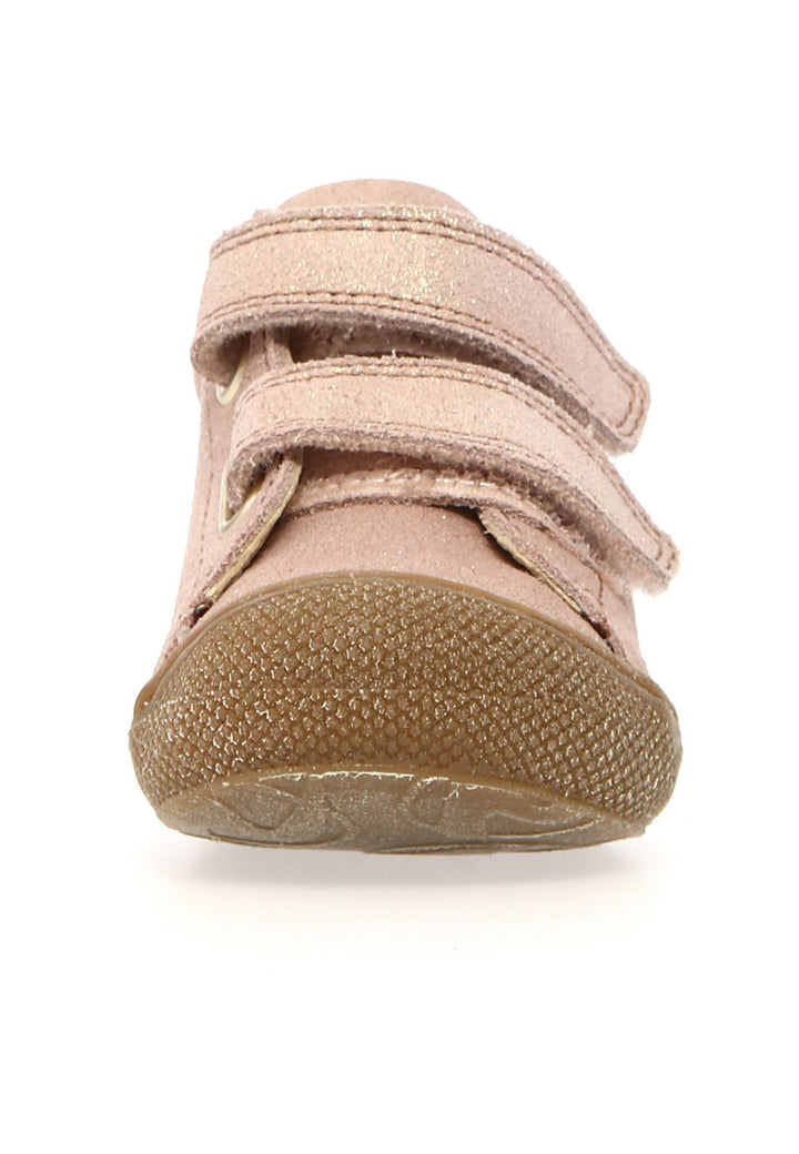 Pink children's shoe with velcro straps on a white background