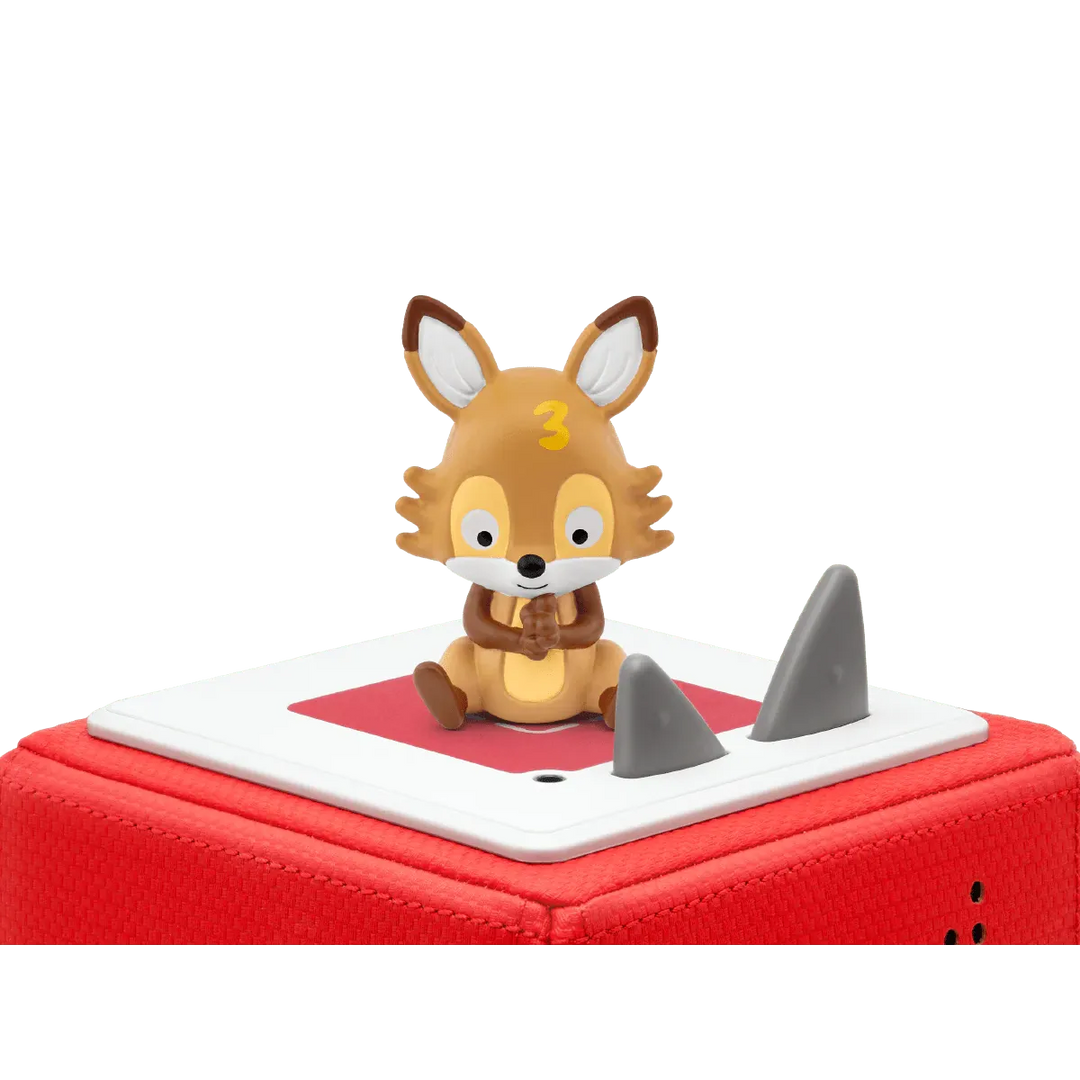 Toy fox figure on a red and white base with shark fin design