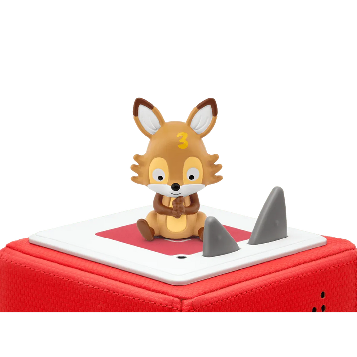 Toy fox figure on a red and white base with shark fin design