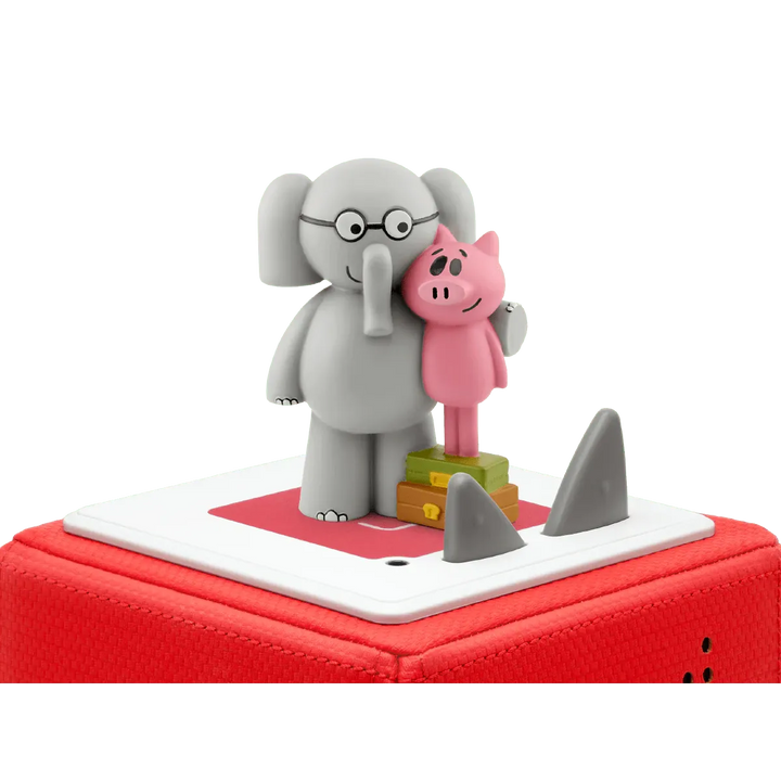 Toy figure of an elephant and a pig on a red base with shark fins.