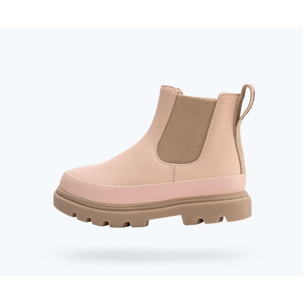 Pink Chelsea boot with a thick sole on a white background