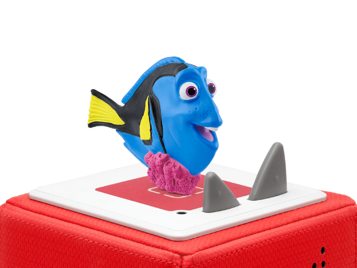 Toy figure of a blue fish with a red base on a white background