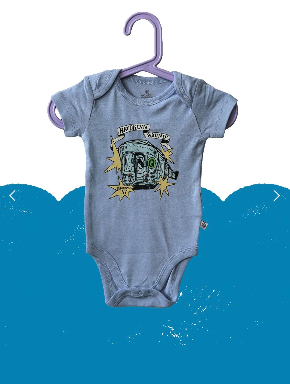 Gray baby onesie with graphic design on a hanger against a blue background