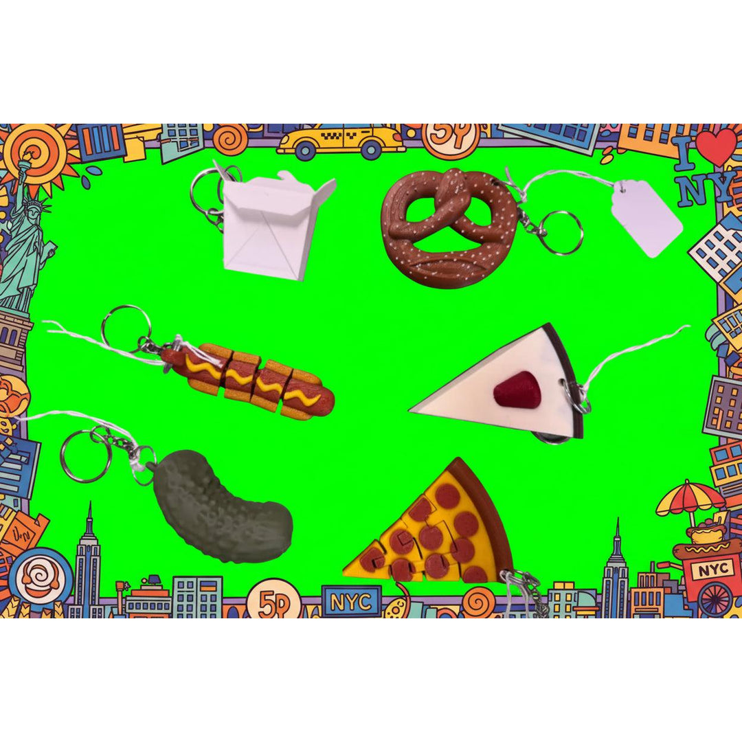 Colorful keychains on a green background with cityscape border