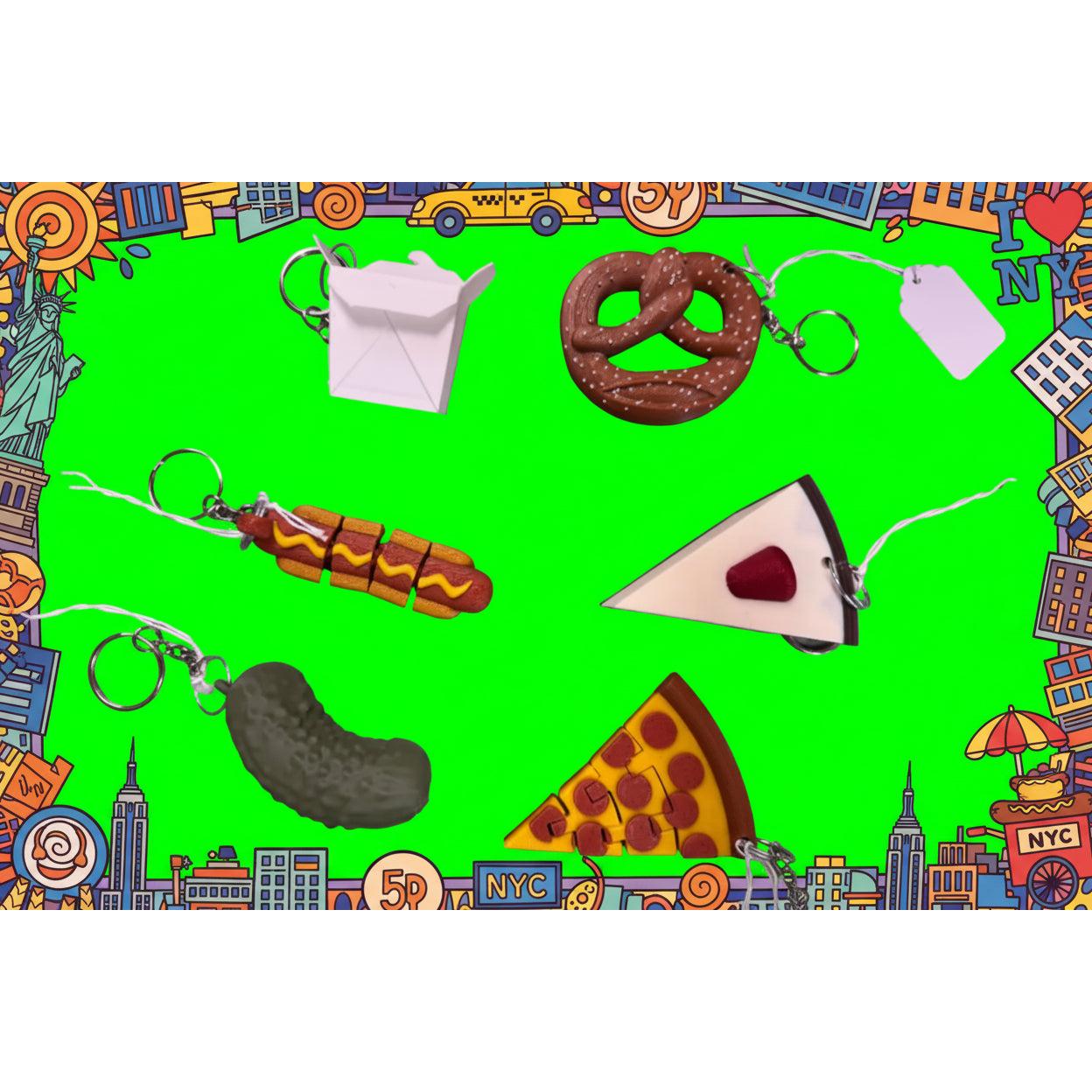 Colorful keychains on a green background with cityscape border