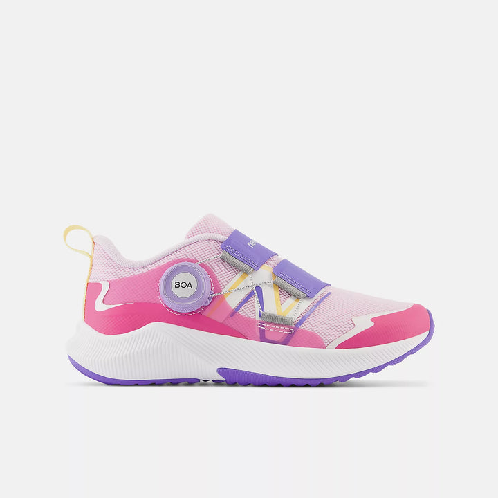 A pink and purple New Balance DynaSoft Reveal v4 BOA running shoe for little kids and big kids, with a modern upper and BOA dial system.