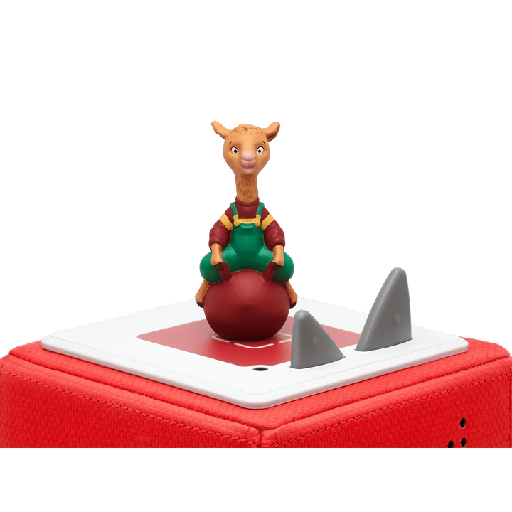 Toy figure of a character on a red ball with shark fin design on a white background