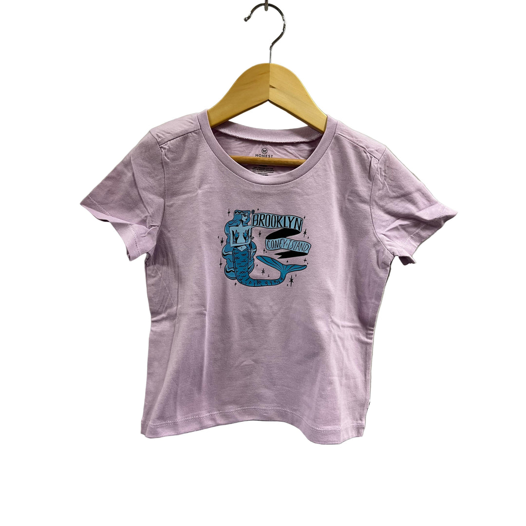 Purple t-shirt with graphic design on a hanger against a light gray wall