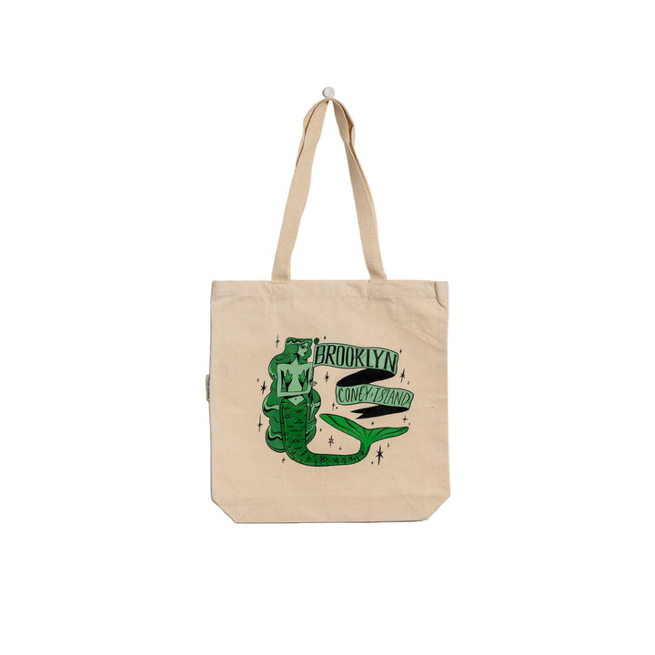 Beige tote bag with green graphic design on a light gray background