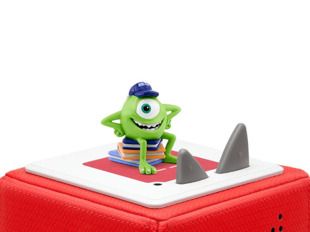 Green toy figure with a blue hat on a red and white base with shark fins.