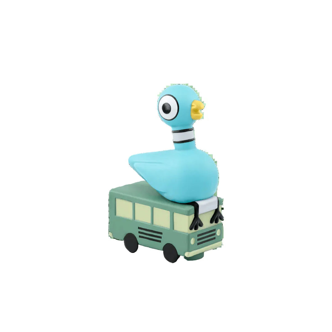 Toy piegon on a toy bus with a white background