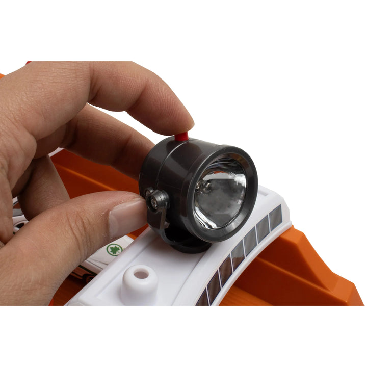 Hand adjusting a small light on a white and orange device