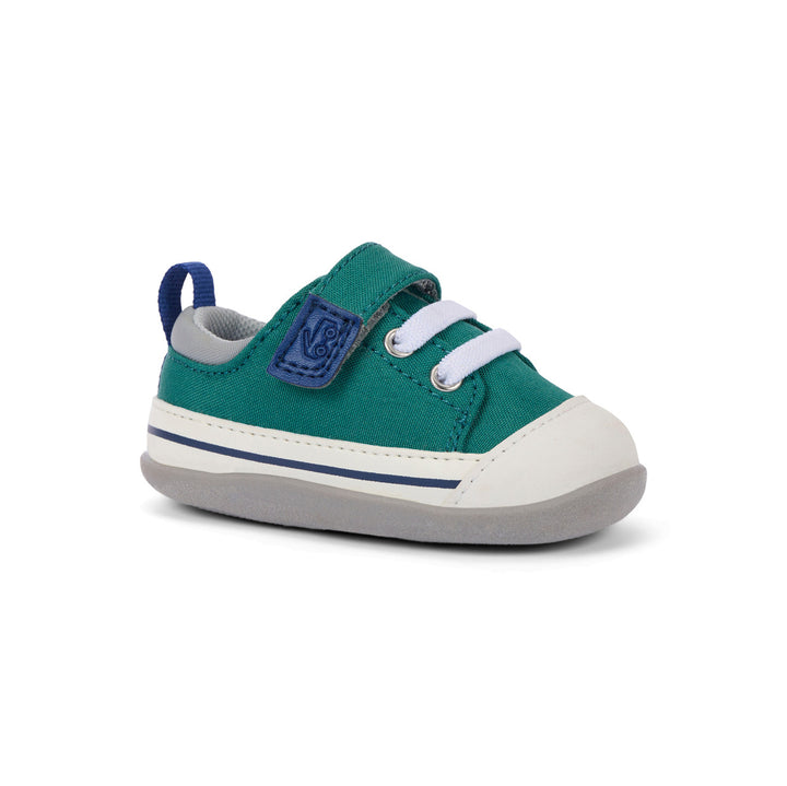 Green children's sneaker with white sole on a white background