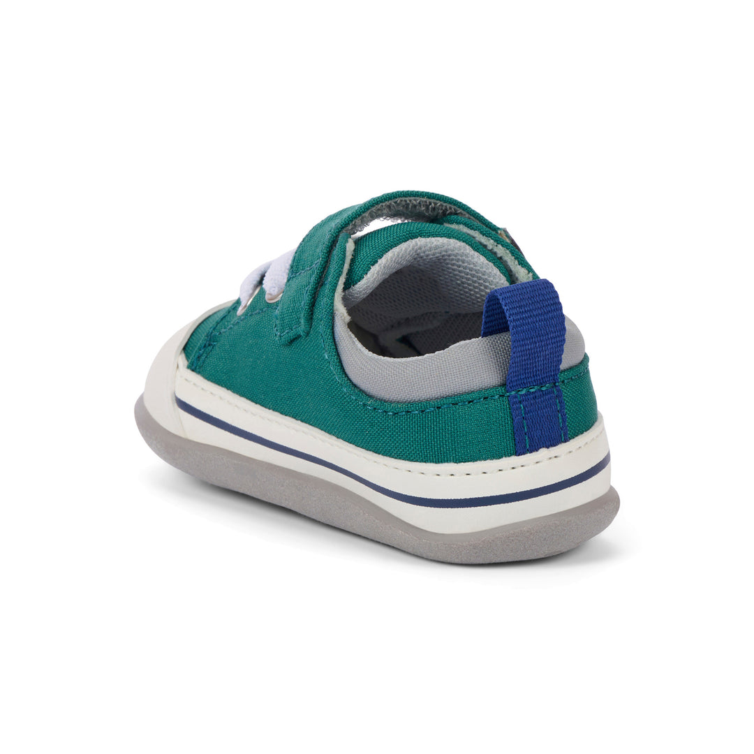 Green and blue children's shoe on a white background