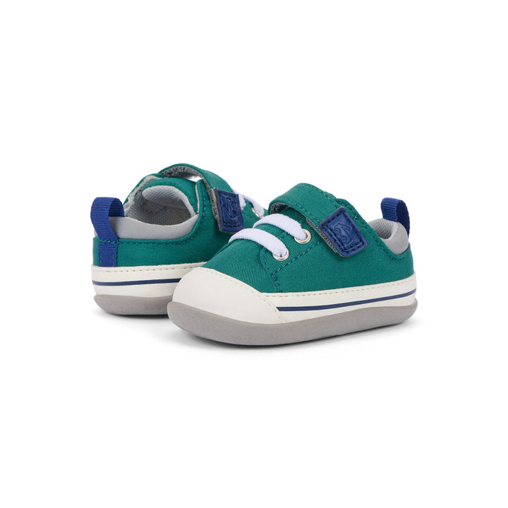 Pair of teal and blue baby shoes on a white background