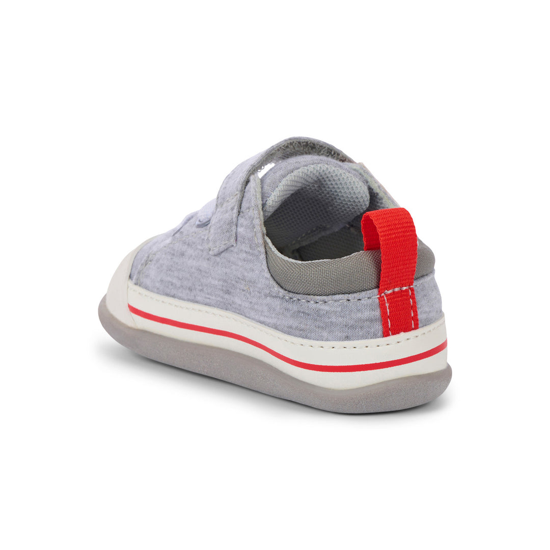 Gray children's shoe with a red strap on a white background