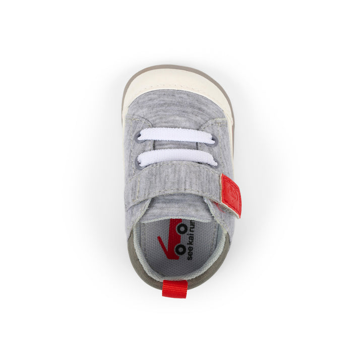 Gray children's shoe with white laces on a white background