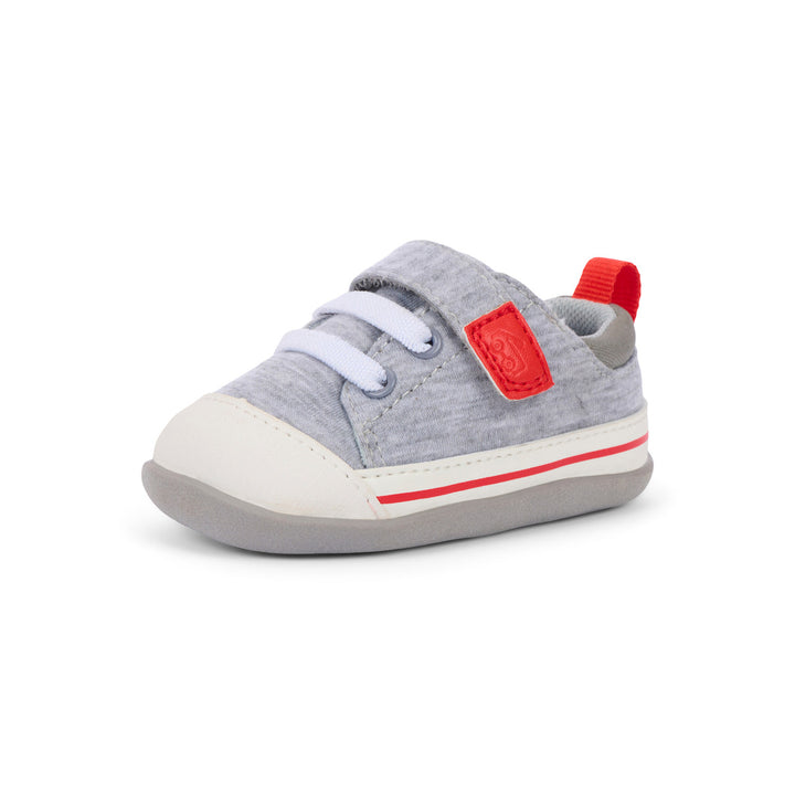 Gray baby shoe with red accents on a white background