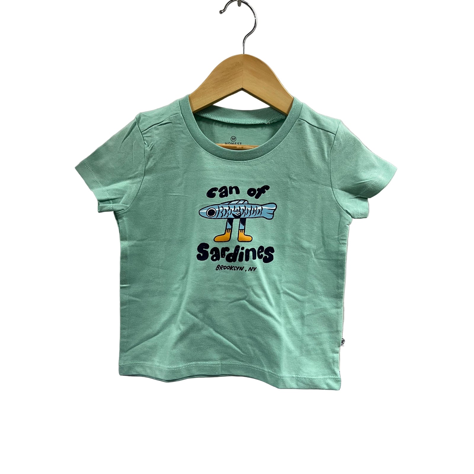 Green t-shirt with a graphic design on a hanger against a gray background