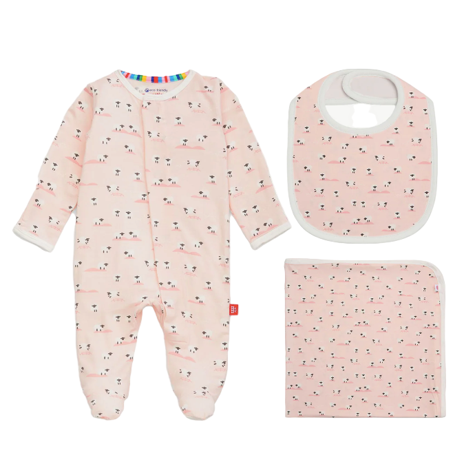 Baby pink outfit set with onesie, bib, and blanket featuring a floral pattern on a white background.