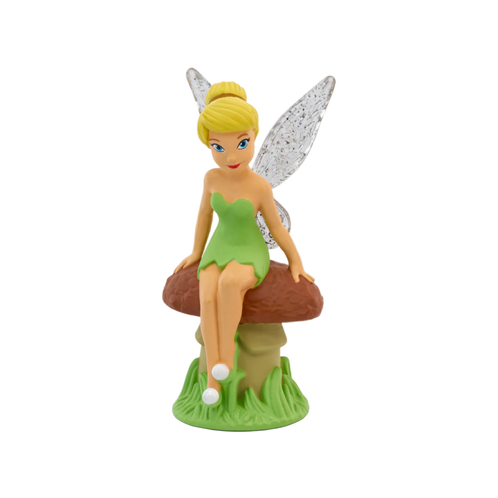 A figurine of Tinker Bell from Disney sitting on a mushroom with a green dress and fairy wings.