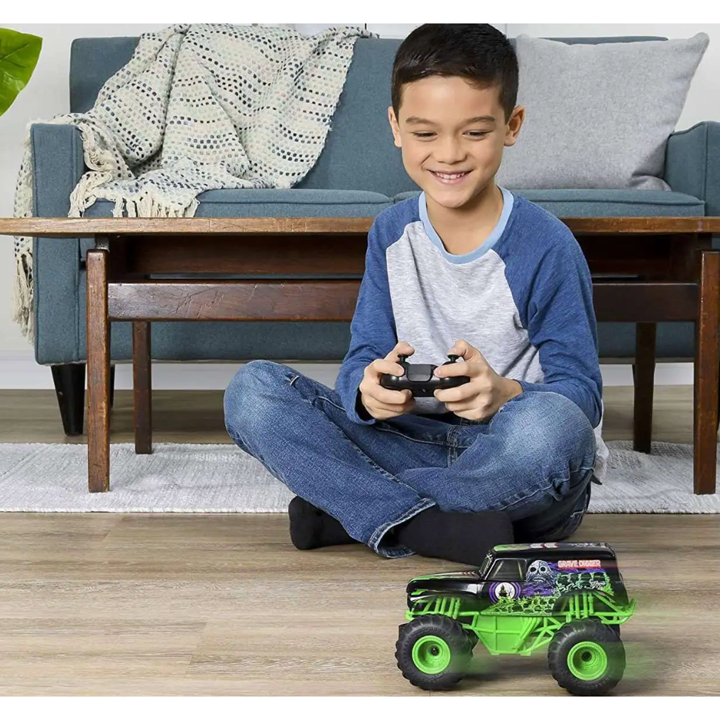 Child playing with a toy truck in a living room