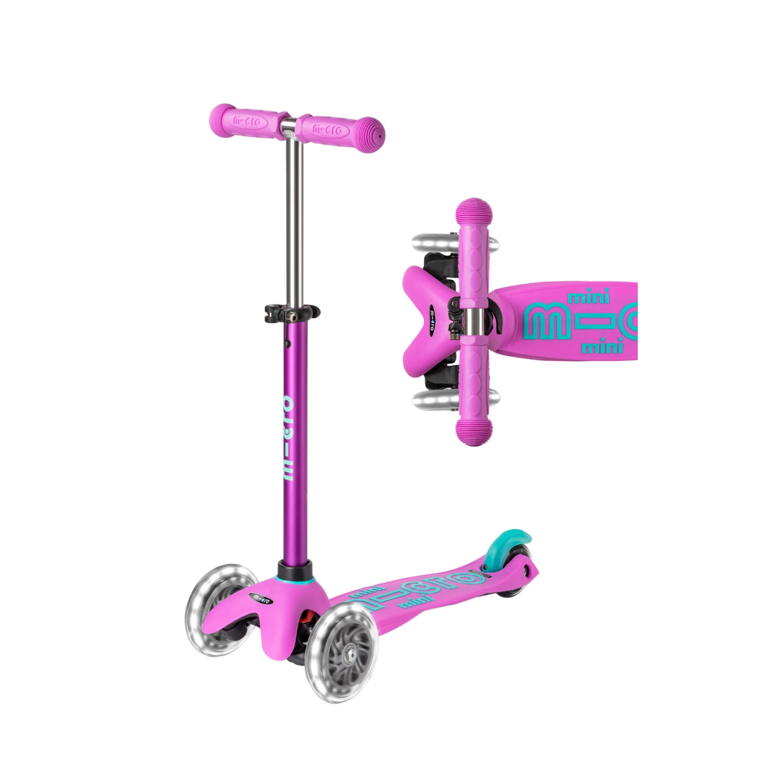 Pink scooter with purple handlebar on a white background