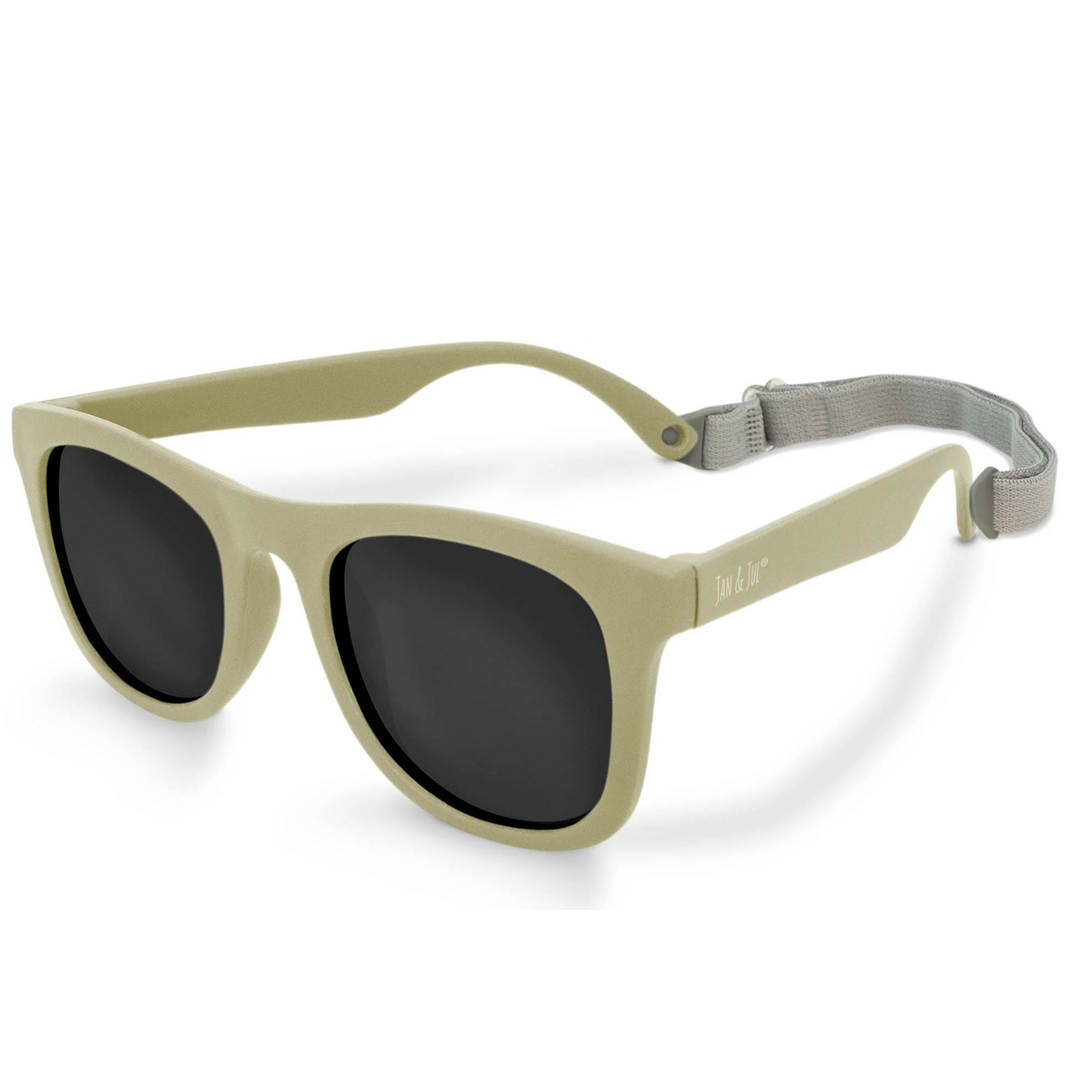 Beige sunglasses with dark lenses and a gray strap to keep from slipping