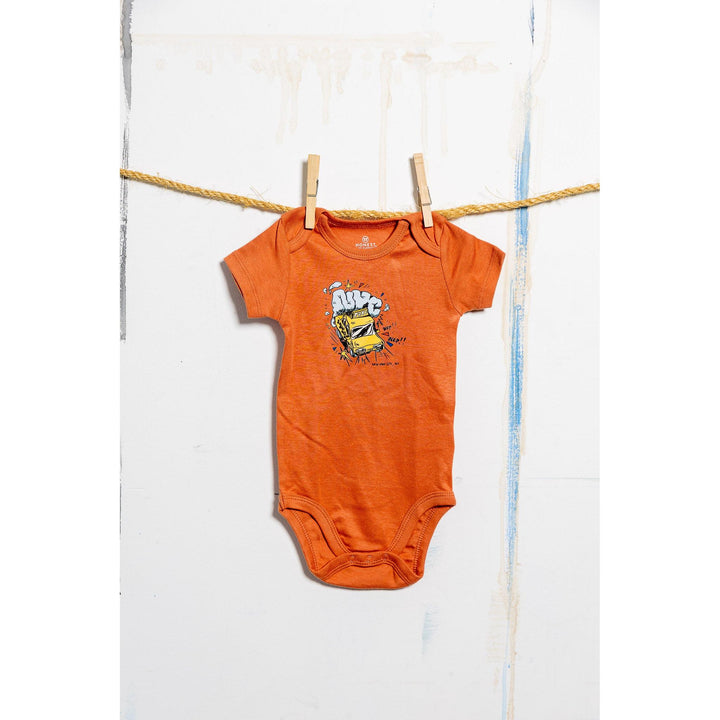 Orange baby onesie with a graphic design hanging on a clothesline.