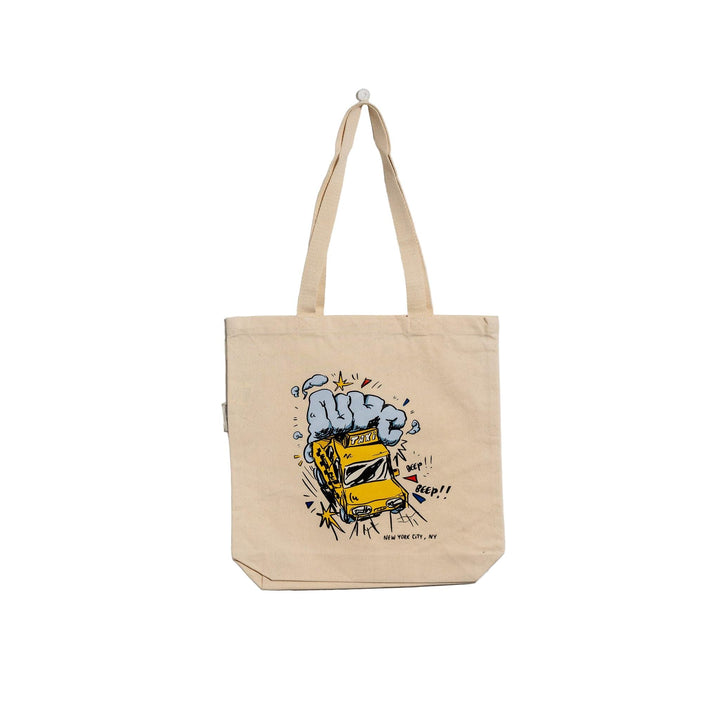 Beige tote bag with a graphic design of a yellow car and blue smoke on a light gray background