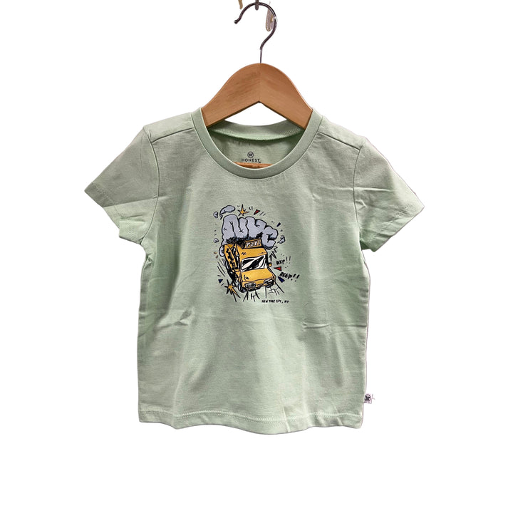 Light green t-shirt with a graphic design on a wooden hanger against a light purple wall.
