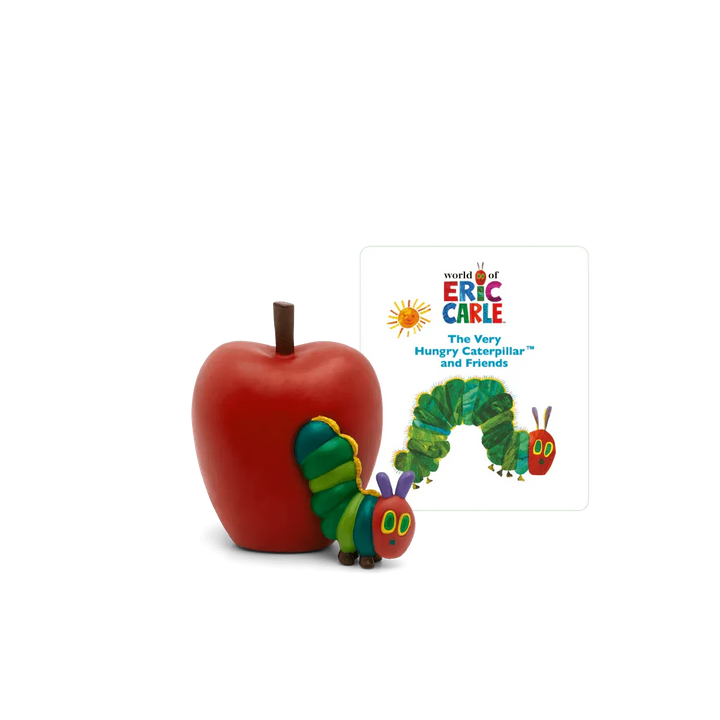 Red apple with a toy caterpillar next to a 'World of Eric Carle' book on a white background